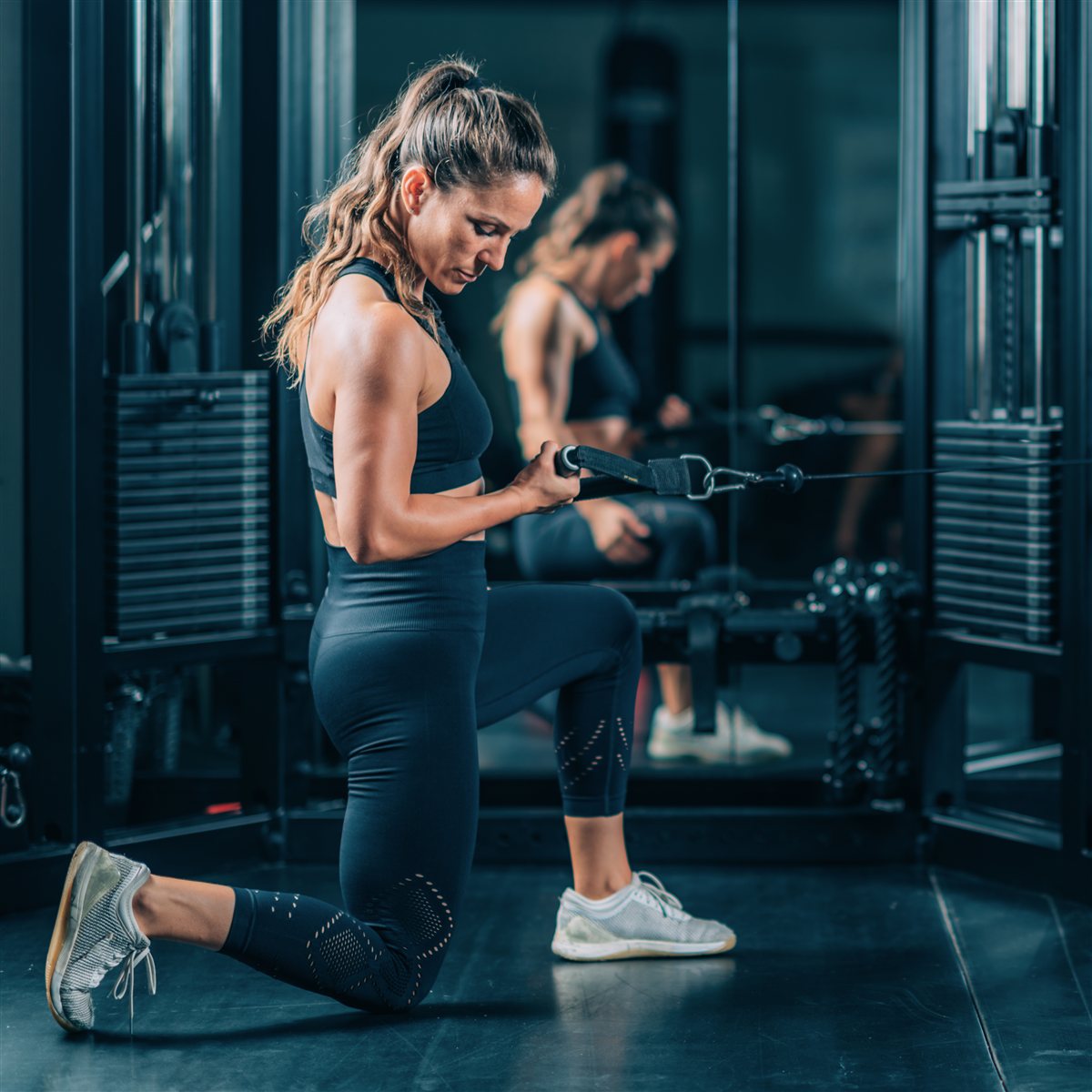 Woman training with a cable machine in the gym