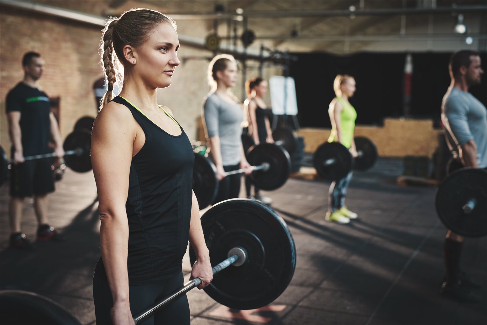 Group training with barbells in the gym